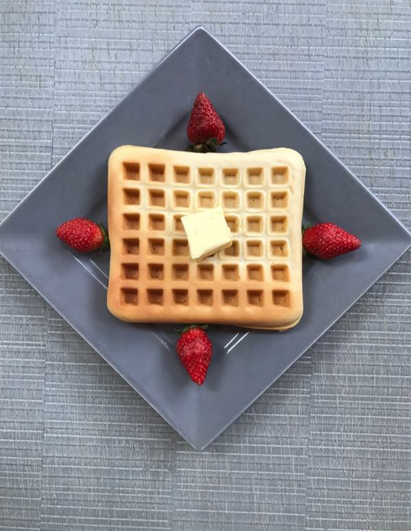 american waffle with mapple syrup and butter